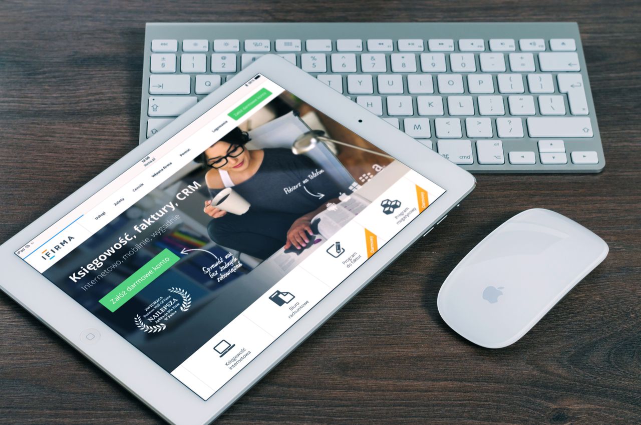 services-03 A tablet with a financial website open, alongside a white keyboard and mouse. Ideal for tech-theme stock images.